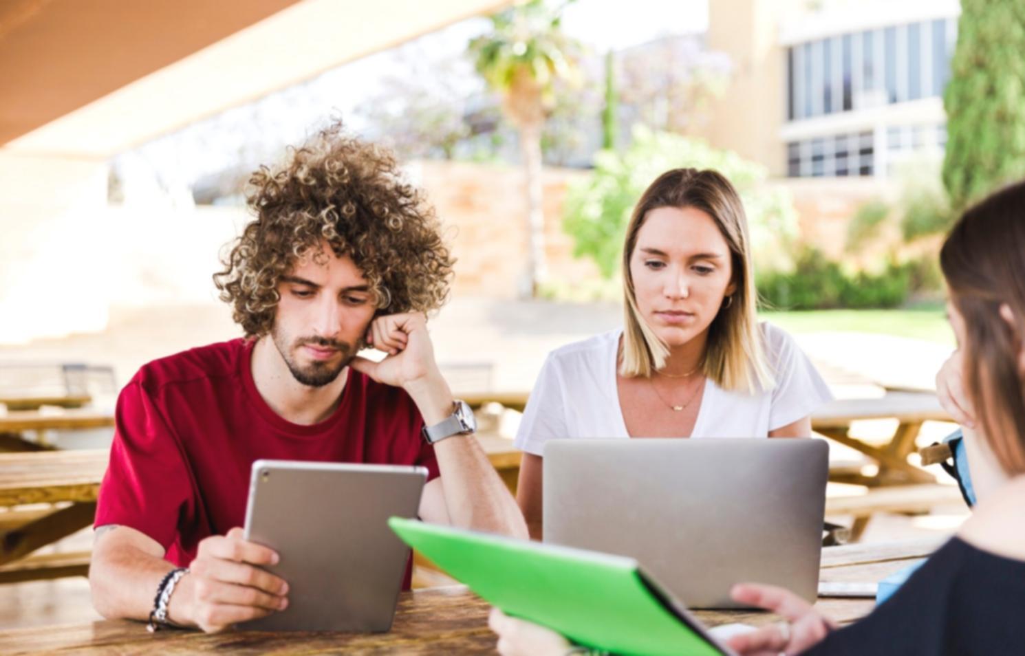 Students learning practical budgeting techniques in collaborative environment
